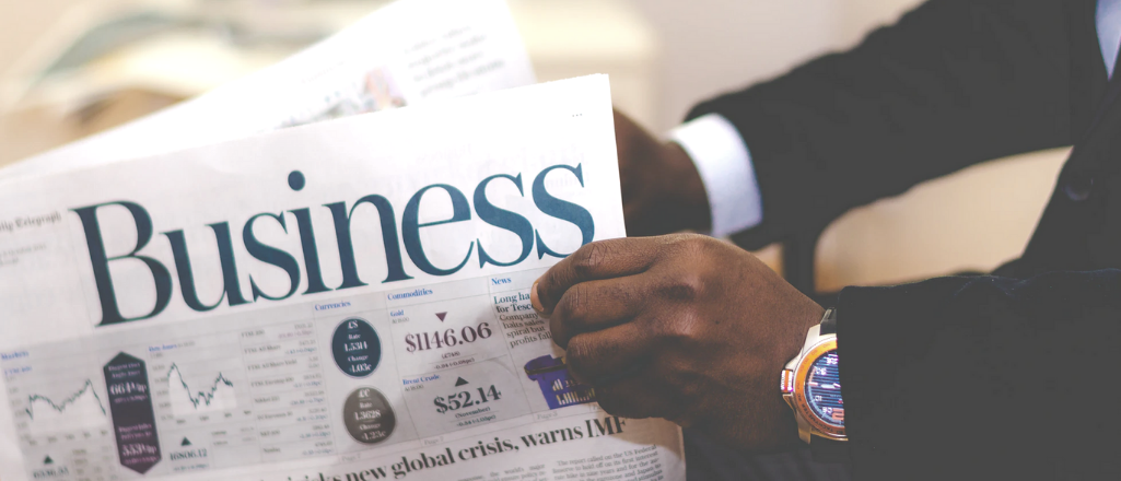 Man in business attire reads the business journal